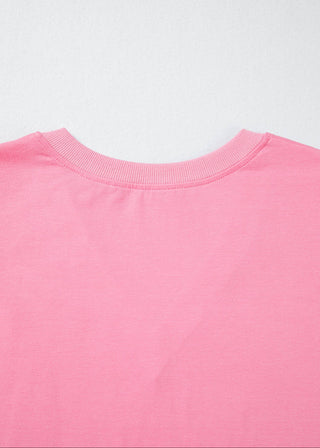 Close-up of a pink shirt with a plain background