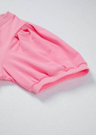 Pink shorts on a light gray background