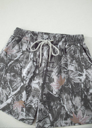Floral patterned shorts with drawstring on a white background