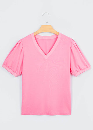 Pink blouse on a hanger against a white background