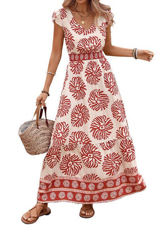 Woman wearing a red and white floral dress holding a straw bag on a white background