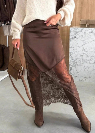 Person wearing a brown skirt with lace detailing in a clothing store.