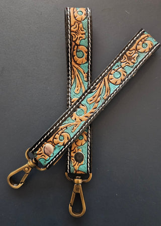 Decorative leather strap with gold and turquoise pattern on a dark gray background