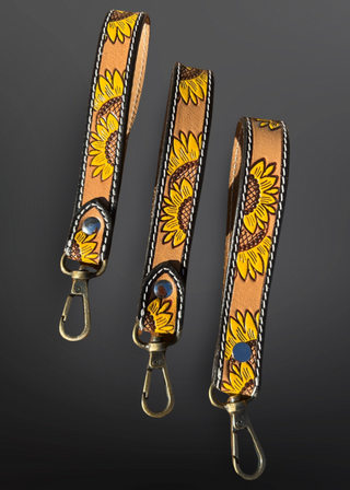Leather straps with sunflower pattern on a dark background