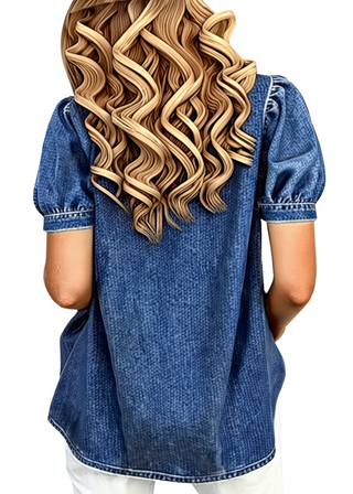 Person wearing a blue denim shirt with a white background
