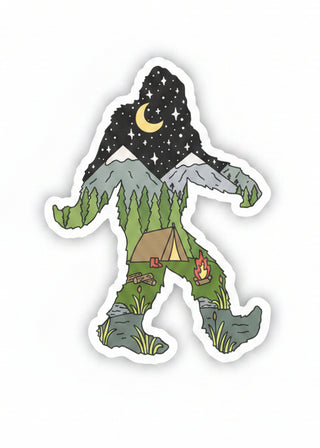 A die-cut vinyl sticker featuring a cartoon Bigfoot silhouette filled with a camping and mountain landscape scene, including a black starry sky with a yellow crescent moon, green trees, gray mountains, a brown tent, and a small campfire, shown on a plain white background.