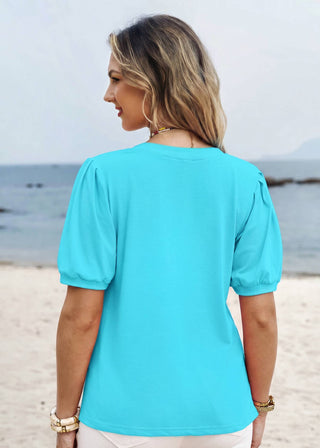 Woman wearing a turquoise top on a beach
