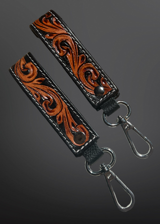 Decorative leather strap with metal clasps on a dark background