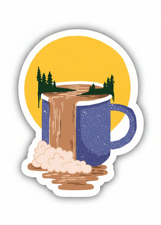 Sticker with a blue mug pouring hot chocolate into a yellow circle with trees, on a white background.