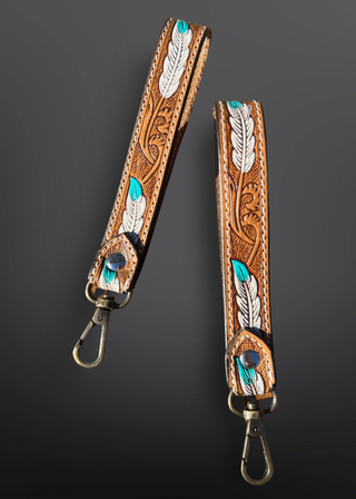 Brown leather strap with feather design on a black background