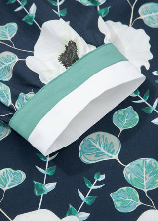 Green headband with white accents on a floral patterned background