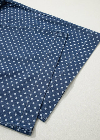Blue fabric with white polka dots on a light gray background