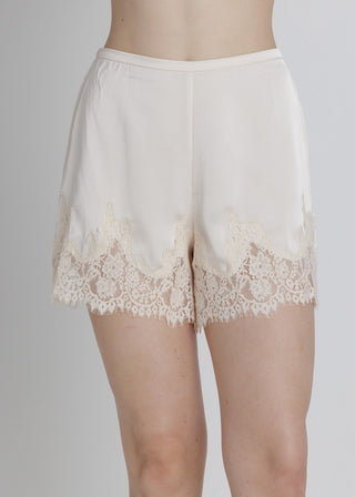 White lace shorts on a plain background