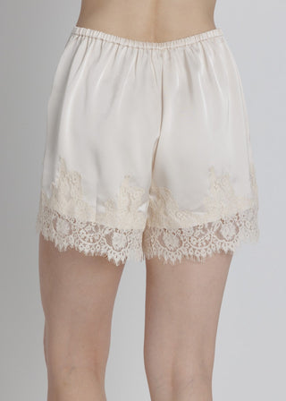 White lace shorts on a gray background
