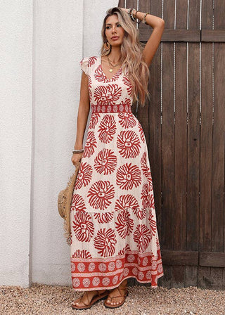 Woman wearing a red and white patterned dress standing against a wooden door.