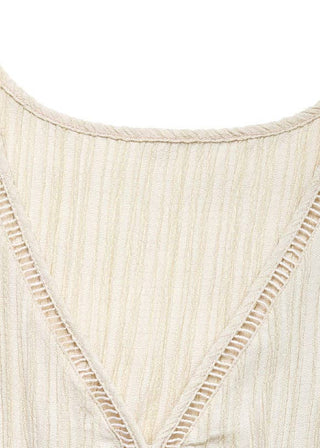 Close-up of a beige textured fabric with a V-neckline on a white background