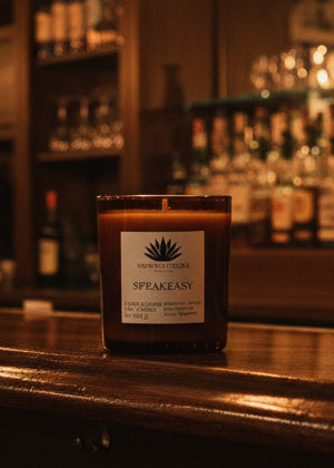 Speakeasy soy candle in an amber glass container