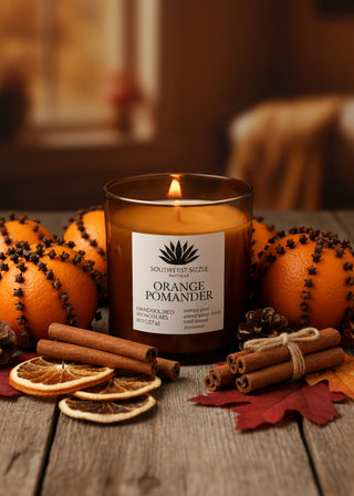 Orange Pomander soy candle in an amber glass container
