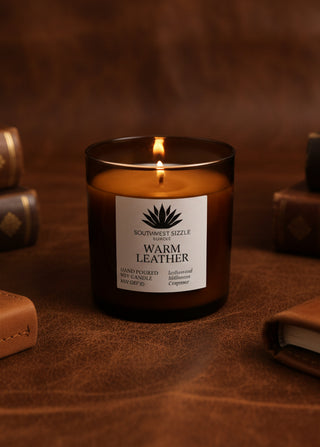 Warm Leather soy candle in an amber glass container