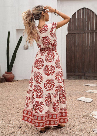 Woman in a red and white patterned dress standing in a desert-like setting with cacti and a wooden door.