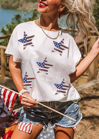 Model wearing white Americana sequin star tee with denim jeans