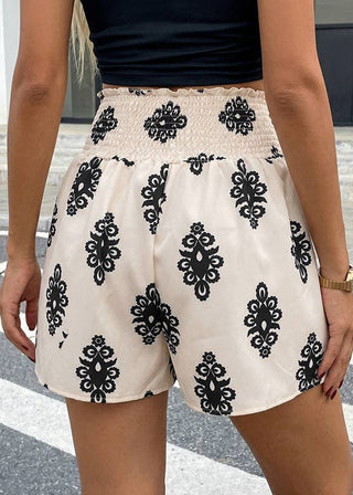 Person wearing a black and white patterned skirt on a city street.