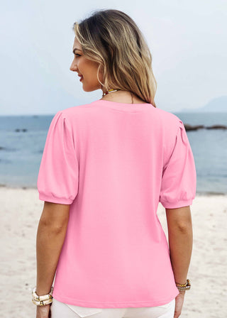 Woman wearing a pink blouse on a beach
