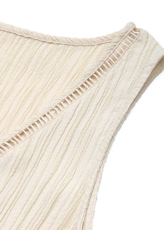Close-up of a beige ribbed fabric sleeveless top on a white background