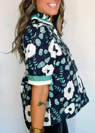 Woman wearing a navy floral kimono against a white background