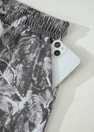 Phone case with leaf pattern on a white surface