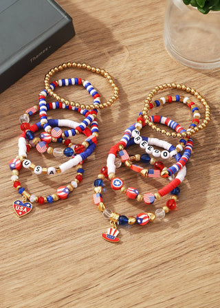 Colorful beaded bracelets with patriotic designs on a wooden surface